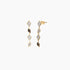 A pair of gold-colored diamond earrings with a geometric pattern, featuring pave diamonds.