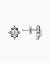 A pair of white gold earrings with a star-shaped design featuring white topaz stones.