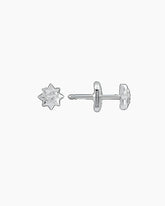 A pair of white gold stud earrings with small diamonds set on them, against a black background.