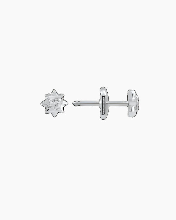 A pair of white gold stud earrings with small diamonds set on them, against a black background.