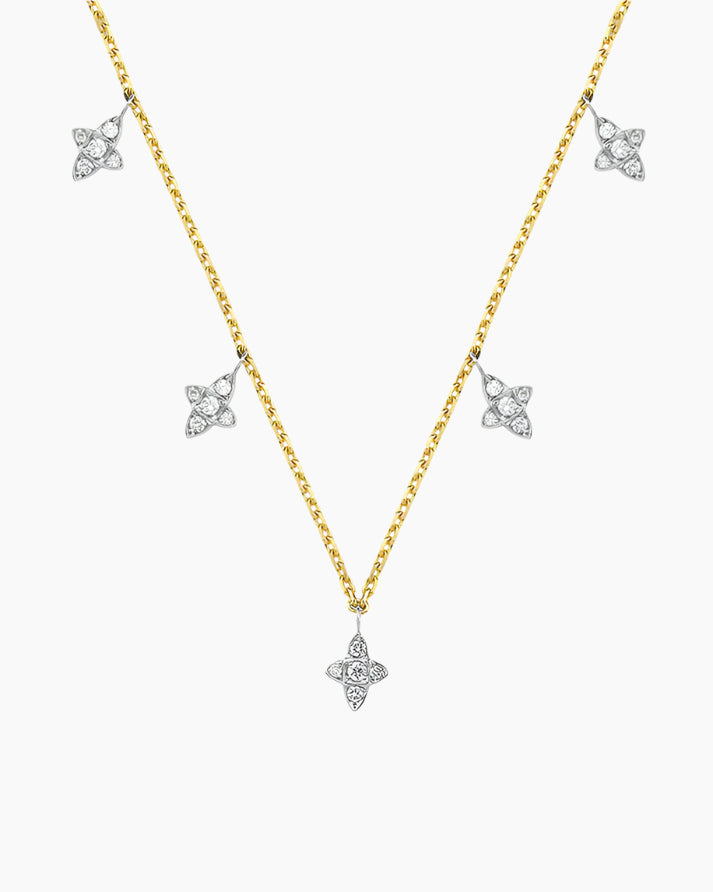 Gold necklace with diamond pendants on a white background