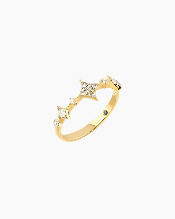 Gold ring with diamond accents on a white background